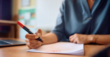 A teacher grades a student's work.