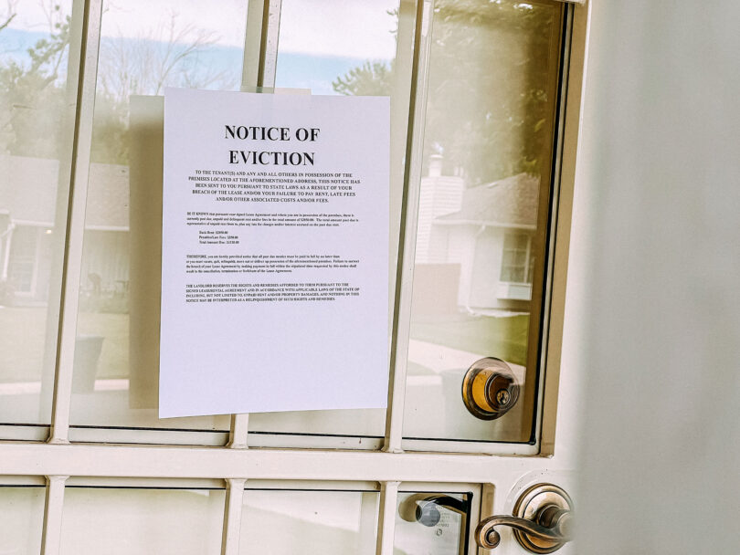 An eviction notice is attached to the door of a home.